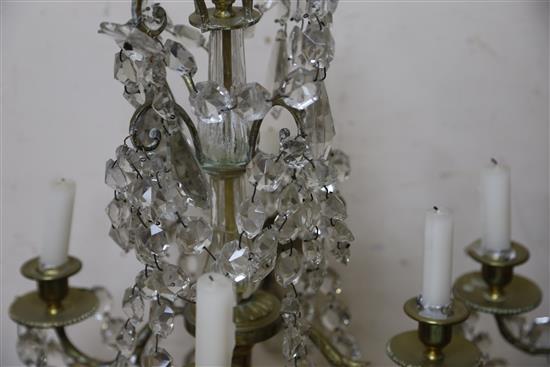 A pair of late 19th century Bohemian brass and lustre hung four branch candelabra, height 60cm (break to stem of one)